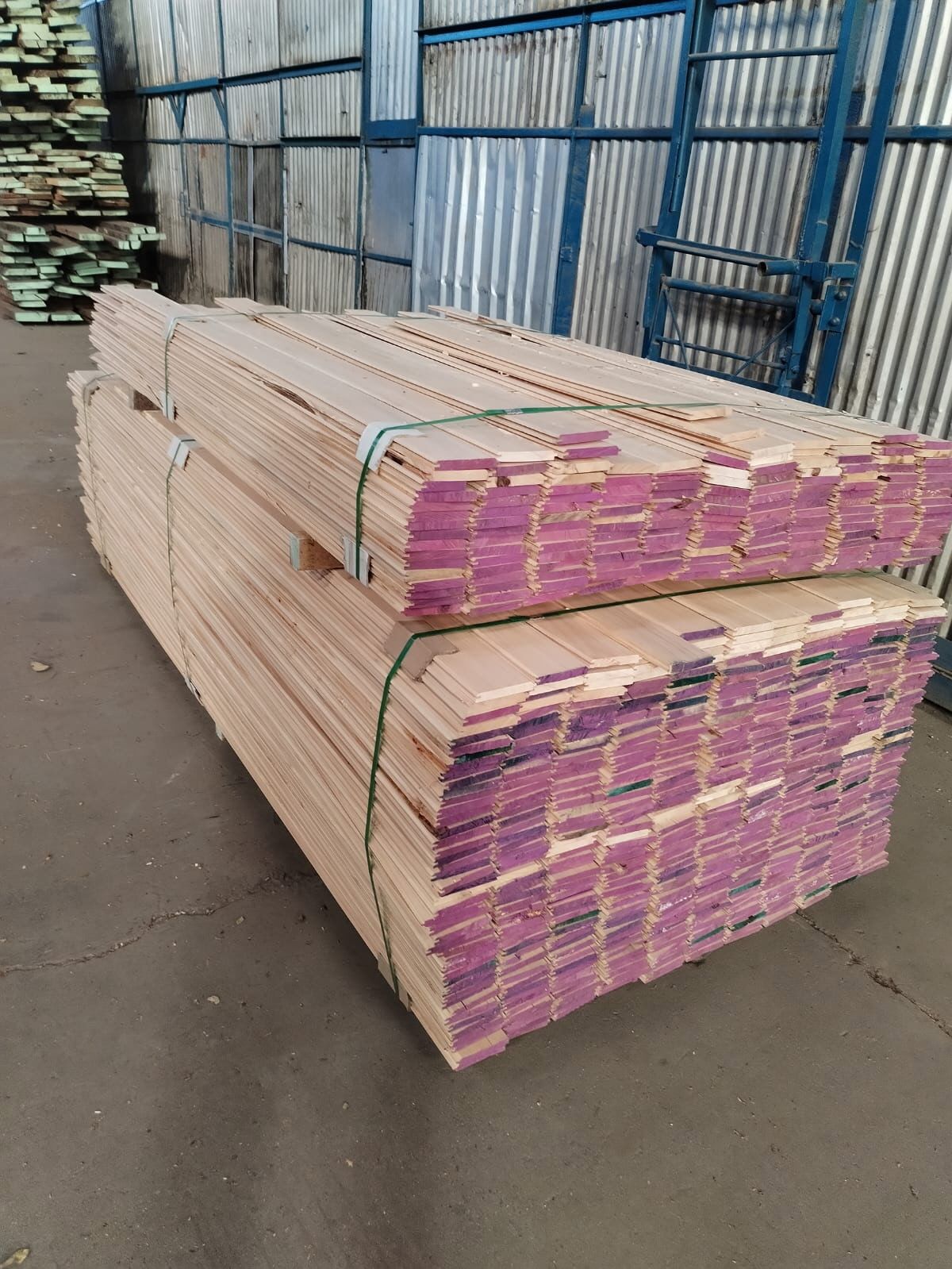 Banded, end-marked cypress lumber bundles in the mill warehouse