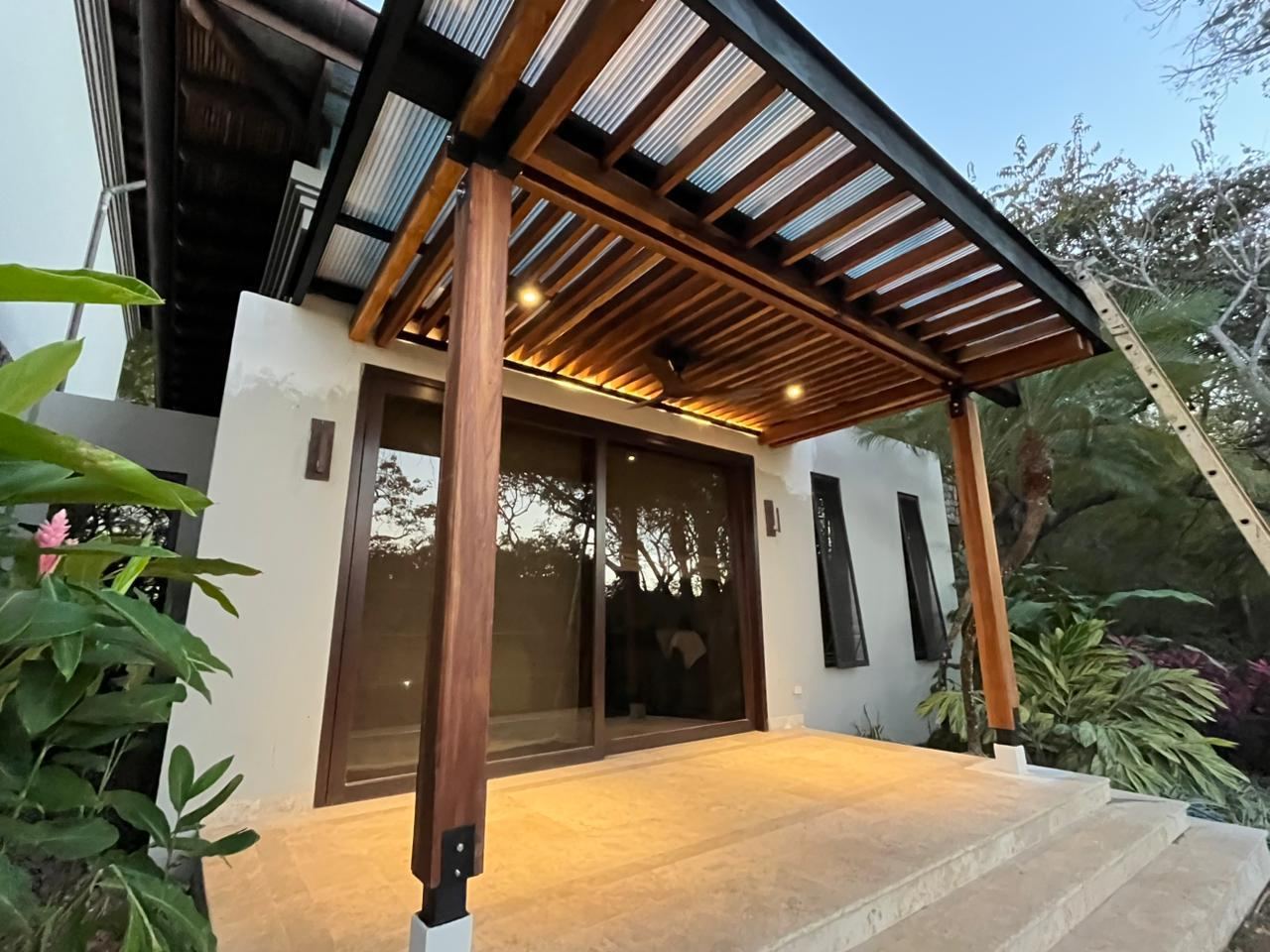 Teak entry pergola at dusk