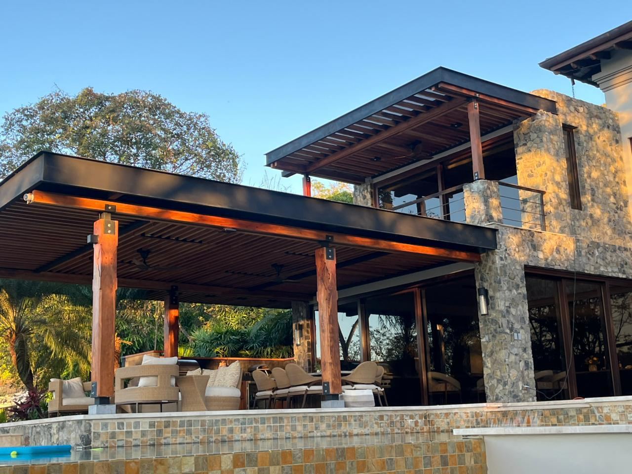 Teak pergola over a poolside patio