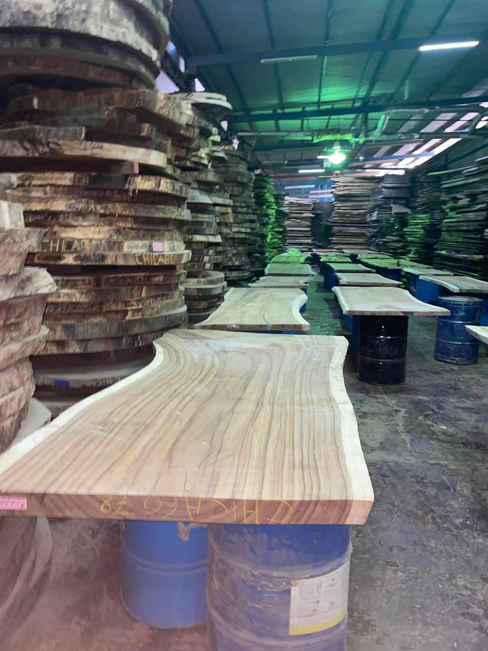 Live-edge slabs stacked at the mill
